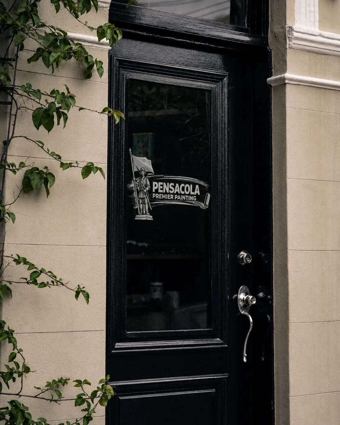 Pensacola Premier Painting logo on the glass of a freshly painted black front door
